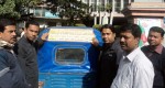 Counselor of 15 no ward of Chittagong City Corporation attaching smoke-free stickers behind the Taxi with the support of YPSA