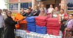 A beneficiary receives warm blanket from Md. Arifur Rahman