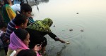 Participants floating candles on a lake