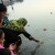 Participants floating candles on a lake