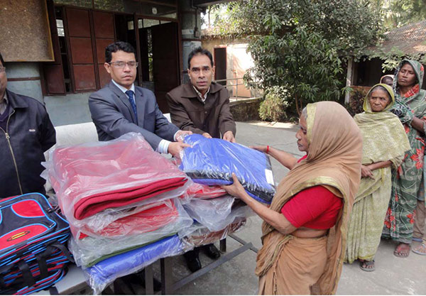 A woman from fisherman community receiving blanket