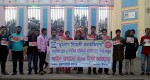 Volunteers standing with banner and sticker in front of Shadhinota park