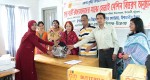 A woman is receiving sewing machine.