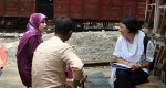 Heidi Chan with an interviewer and respondent in the field