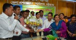 DC receiving flower bouquet from NGO representatives
