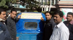 Counselor of 15 no ward of Chittagong City Corporation attaching smoke-free stickers behind the Taxi with the support of YPSA