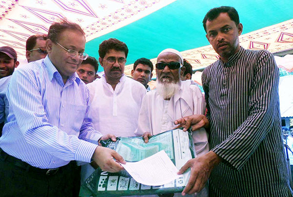 State Minister for Environment and Forests Dr Hasan Mahmud distributing insecticide-treated mosquito net