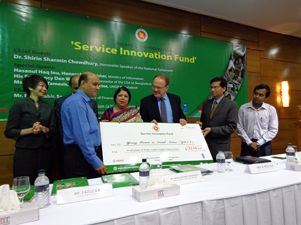 Mr. Vashkar Bhattacharjee receiving award from honorable speaker of the national parliament Dr Shirin Sharmin Chowdhury and Dan W Mozena, The Ambassador of USA in Bangladesh