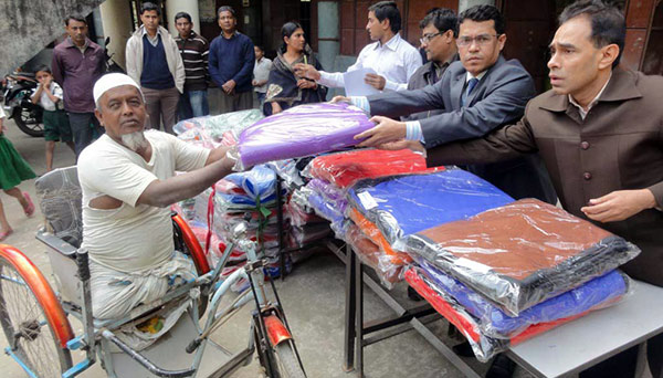 A PWD receiving blanket from Mohammad Shahin Imran, Upazila Nirbahi Officer, Sitakund