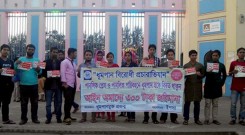 Volunteers standing with banner and sticker in front of Shadhinota park