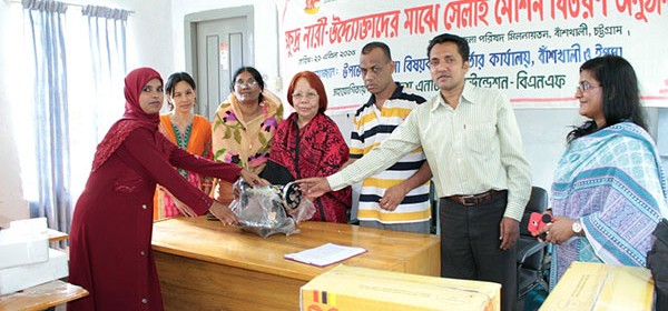 A woman is receiving sewing machine.