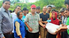 YPSA and WFP officials distributes rice bag to a female member of a Rohingya family
