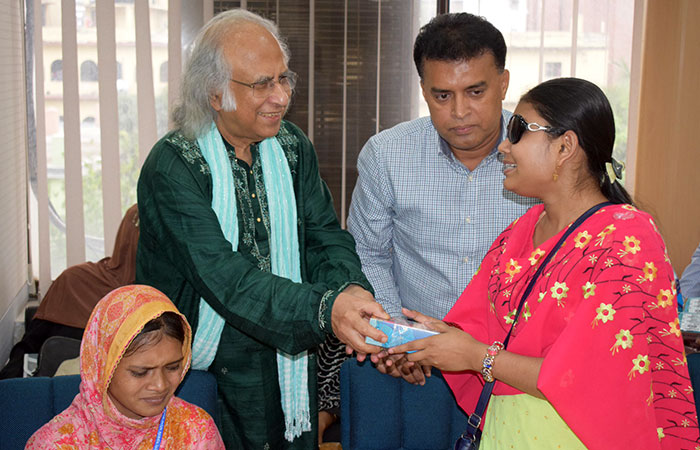 PKSF chairman handovers a phone to a woman with visually umpired student 2