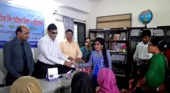 Mansur Ahmed Chaudhary handovers smartphone to a visually challenged woman student