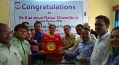 A plaque is handover to Dr. Shamsun Nahar Chowdhury