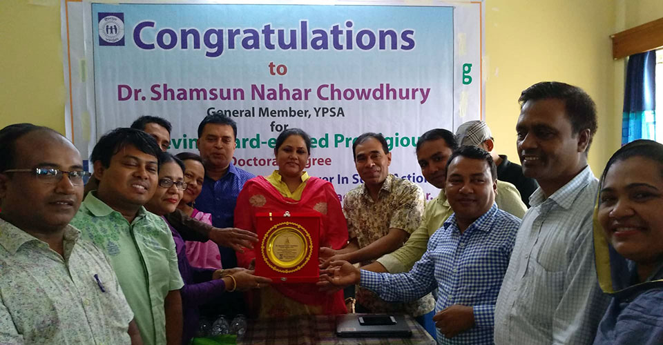 A plaque is handover to Dr. Shamsun Nahar Chowdhury