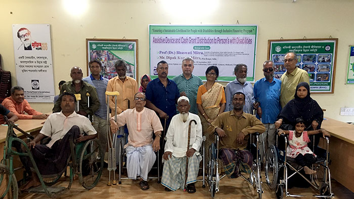 Visitor in a group photo of PWDs 