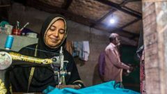 A women with disability sewing with her sewing machine