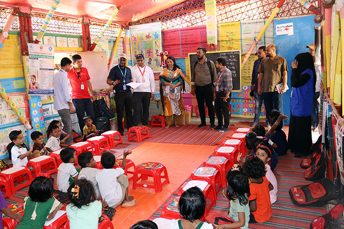 Visitors with children at YPSA learning center in Rohingya camp. 