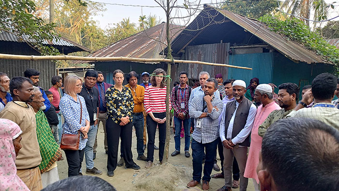 Visitors at the flood affected area talking with community people.