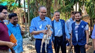 Deputy Managing Director of PKSF walking with doeling accros the village