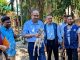 Deputy Managing Director of PKSF walking with doeling accros the village