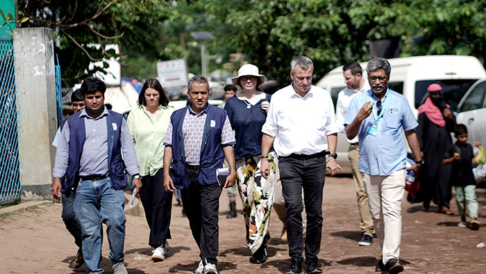 Landscape group photo. The team walking across the camp