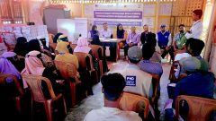 Visitors interact with Rohingya man and woman