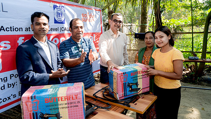 Indigenous adult girl receiving sewing machine