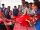 Vulnerable people receiving tarpaulins