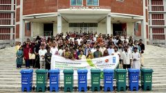Group photo of students with phatic bin and banner