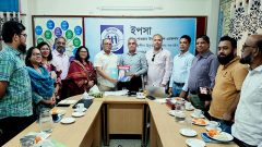 Presenting book to the Norwegian Refugee Council Country Director Mr. Dipankar Datta